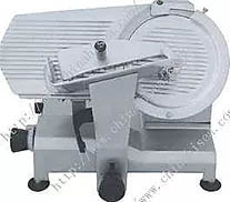 Commercial meat slicer. Gray machine with circular blade, food carriage, and thickness adjustment knob.